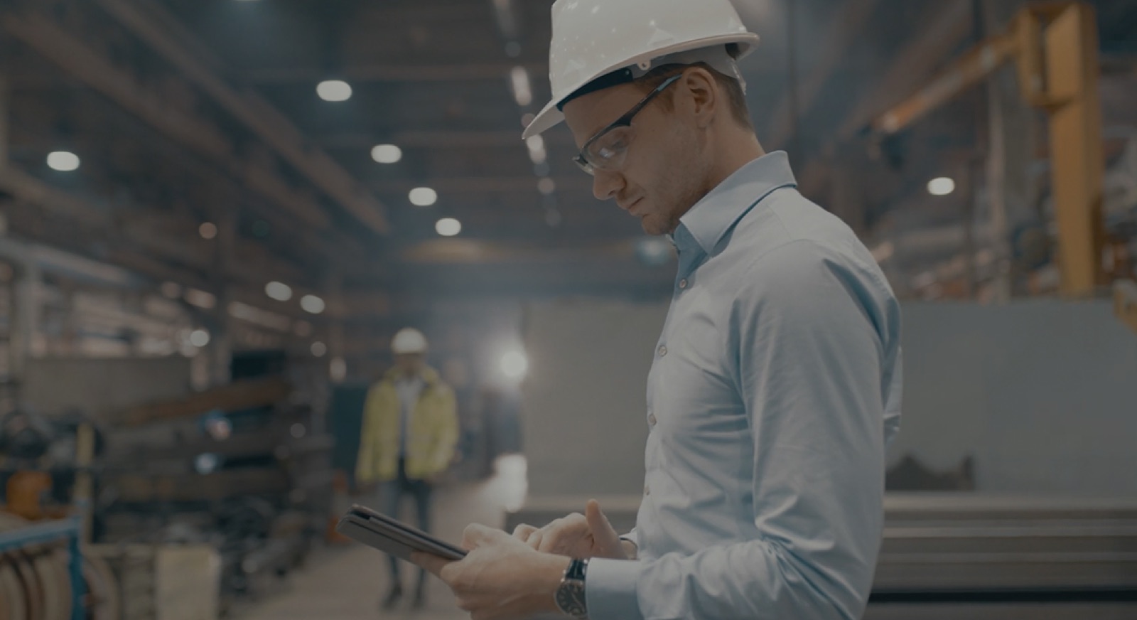 An engineer using industrial software on a tablet